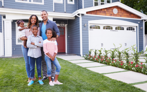 Black family in front of a single family home